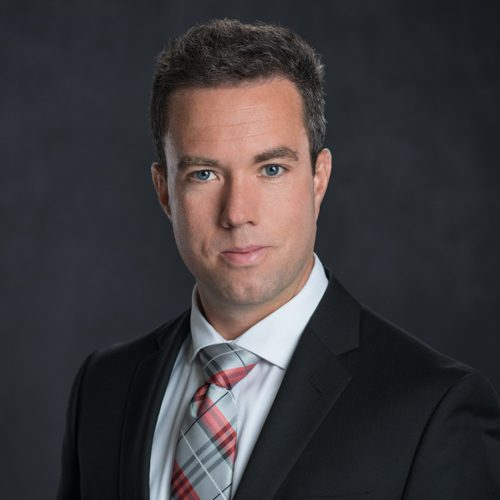 Ji's headshot, smiling with black tee